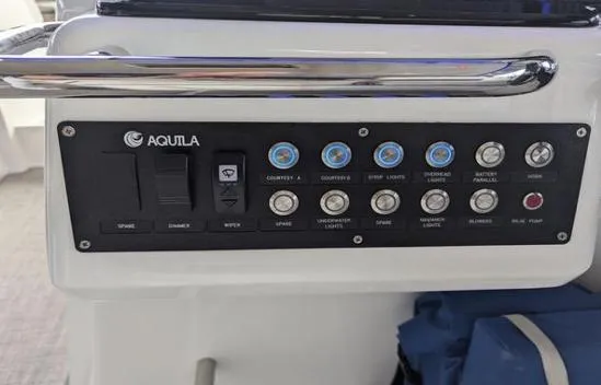 Slide: The Image of Control panel of 2020 Aquila 36 Sport boat with labeled switches and buttons. - 12