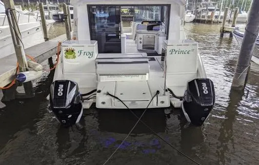 Slide: The Image of Aquila 36 Sport 2020 boat docked with twin 300 horsepower engines. - 13