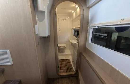 Slide: The Image of Interior of 2020 Aquila 36 Sport yacht, featuring a compact bathroom with modern amenities. - 16