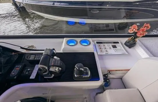 Slide: The Image of Helm of 2020 Aquila 36 Sport boat with controls, gauges, and decorative flowers. - 4