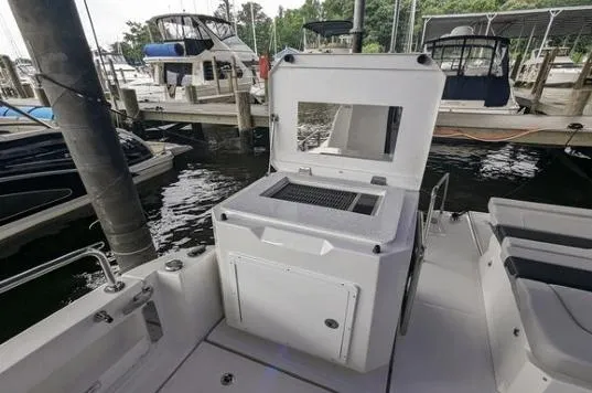 Slide: The Image of Aquila 36 Sport 2020 boat with open storage compartment at marina dock. - 9