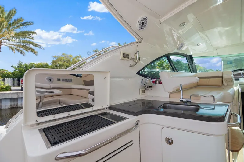 Slide: The Image of 2013 Sea Ray 410 Sundancer yacht with outdoor kitchen and seating area. - 28