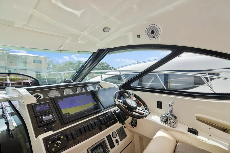 Slide: The Image of Helm of 2013 Sea Ray 410 Sundancer yacht with modern navigation equipment and steering wheel. - 31