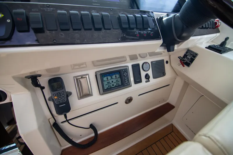 Slide: The Image of Control panel of 2013 Sea Ray 410 Sundancer boat with navigation and communication equipment. - 34