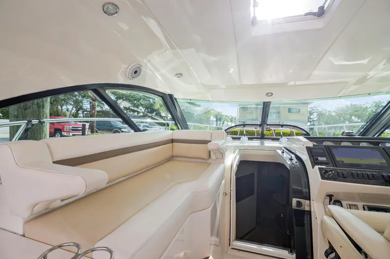Slide: The Image of Luxurious interior of 2013 Sea Ray 410 Sundancer yacht with plush seating and modern controls. - 36