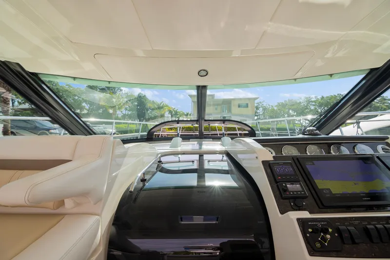 Slide: The Image of Interior view of 2013 Sea Ray 410 Sundancer yacht cockpit with modern controls and seating. - 37
