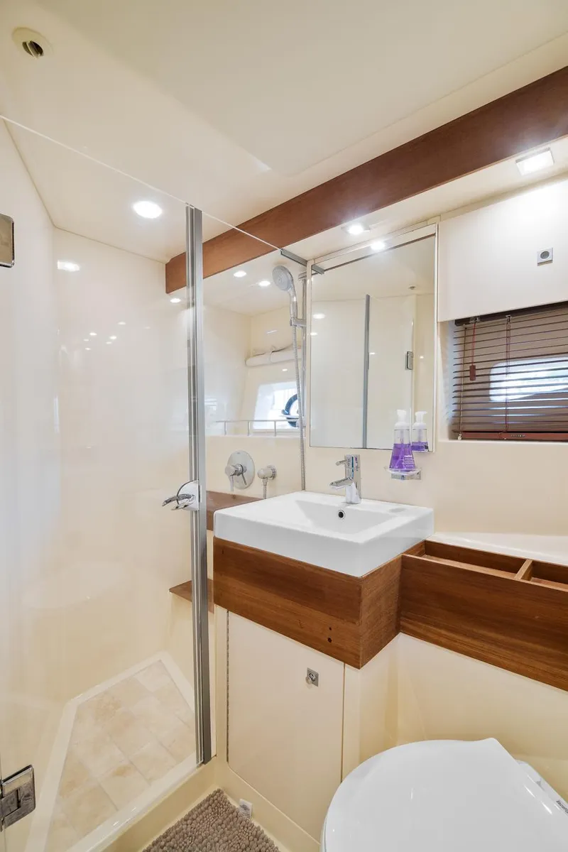 Slide: The Image of Luxurious bathroom in 2013 Sea Ray 410 Sundancer yacht with modern fixtures and elegant design. - 39