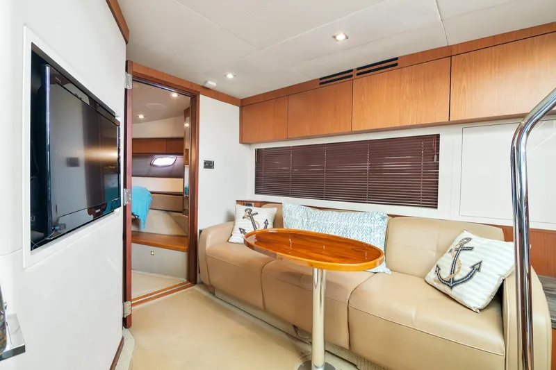 Slide: The Image of Luxurious interior of 2013 Sea Ray 410 Sundancer yacht with beige seating and wooden accents. - 40