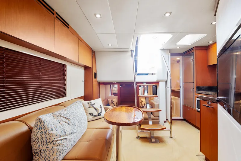 Slide: The Image of Interior of 2013 Sea Ray 410 Sundancer yacht with modern furnishings and wooden accents. - 41