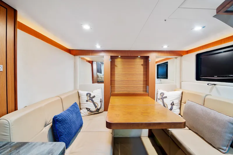 Slide: The Image of Luxurious interior of 2013 Sea Ray 410 Sundancer yacht with elegant seating and wooden table. - 44