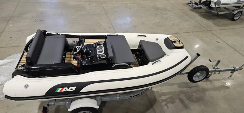 Slide: The Image of 2025 AB Inflatables 330 Jet Boat on trailer in a showroom setting. - 6