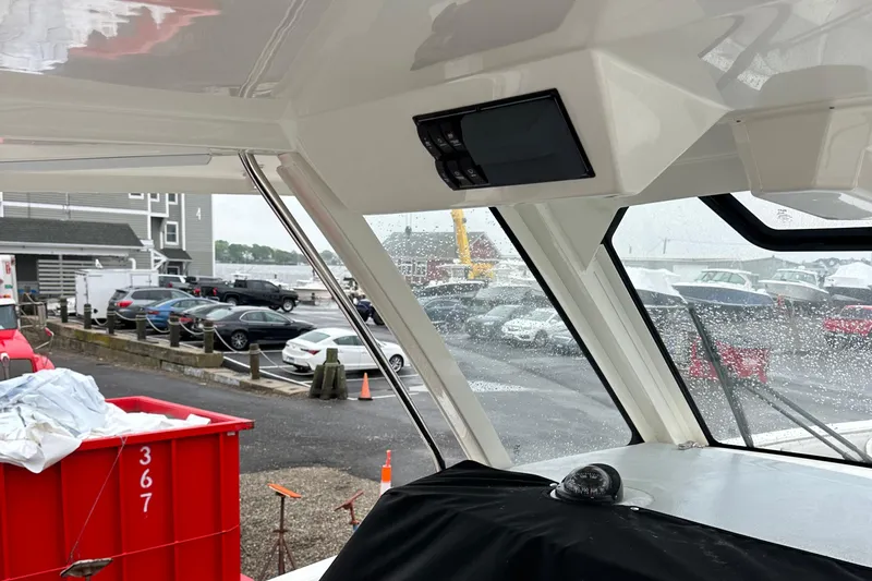 Slide: The Image of 2024 Pursuit S 328 Sport boat interior with marina view through windows. - 12