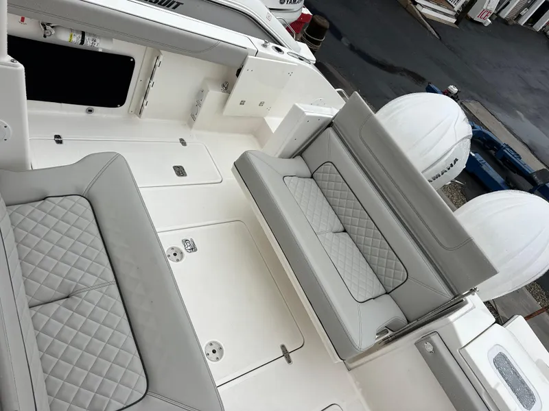 Slide: The Image of 2024 Pursuit S 328 Sport boat interior with quilted seating and modern design. - 18