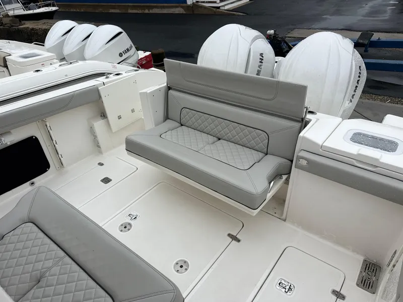 Slide: The Image of 2024 Pursuit S 328 Sport boat with gray seating and Yamaha outboard engines. - 19