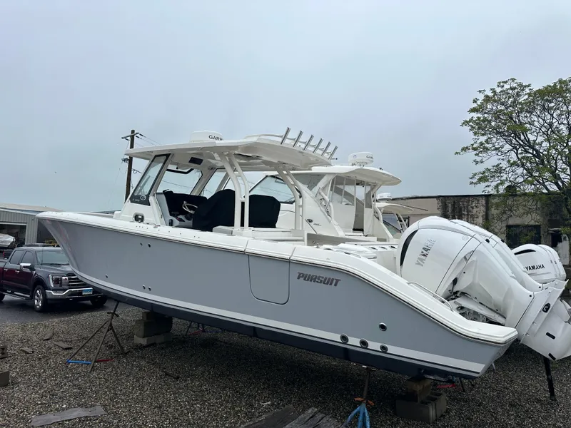 Slide: The Image of 2024 Pursuit S 328 Sport boat on display, featuring sleek design and powerful engines. - 2