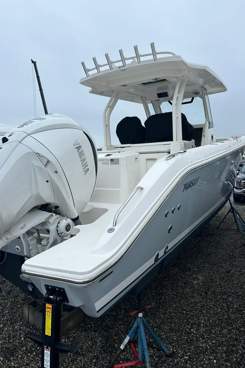 Slide: The Image of 2024 Pursuit S 328 Sport boat with Yamaha engine, displayed on a stand. - 22