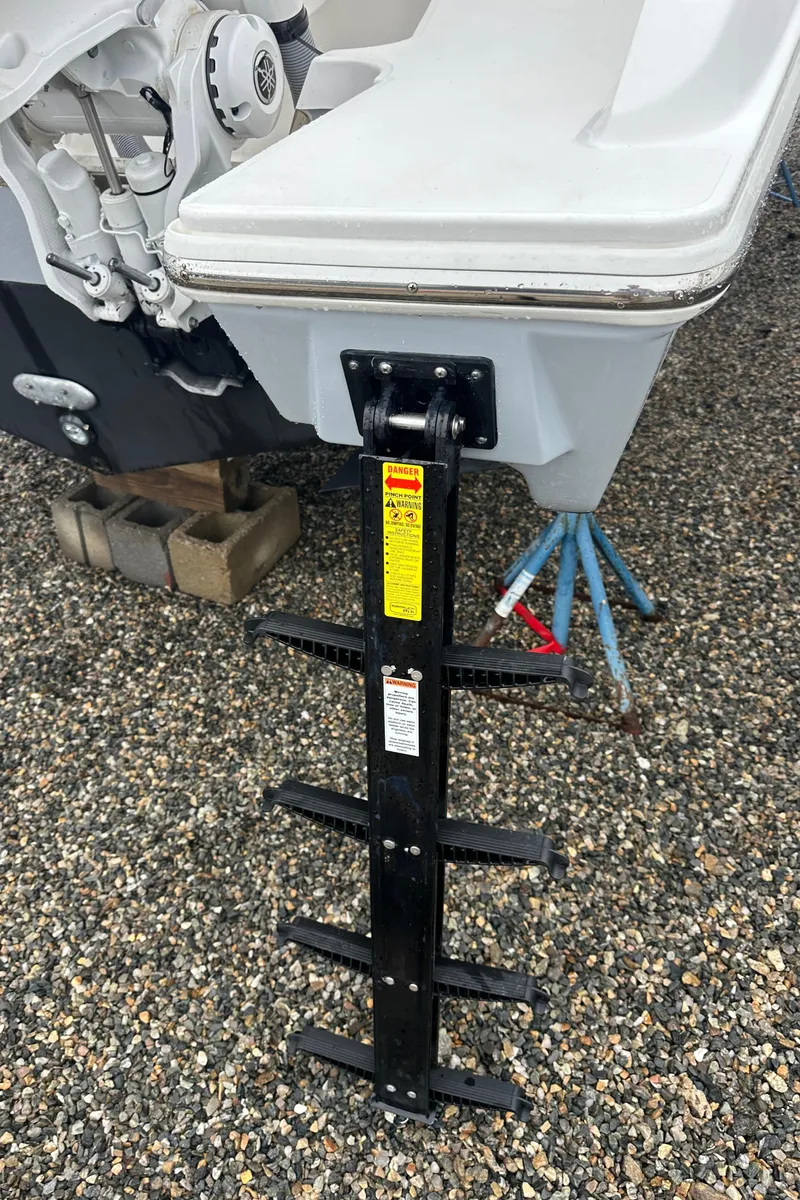 Slide: The Image of 2024 Pursuit S 328 Sport boat ladder on gravel surface. - 23