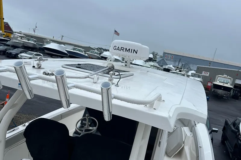 Slide: The Image of 2024 Pursuit S 328 Sport boat with Garmin equipment, docked in a marina. - 24