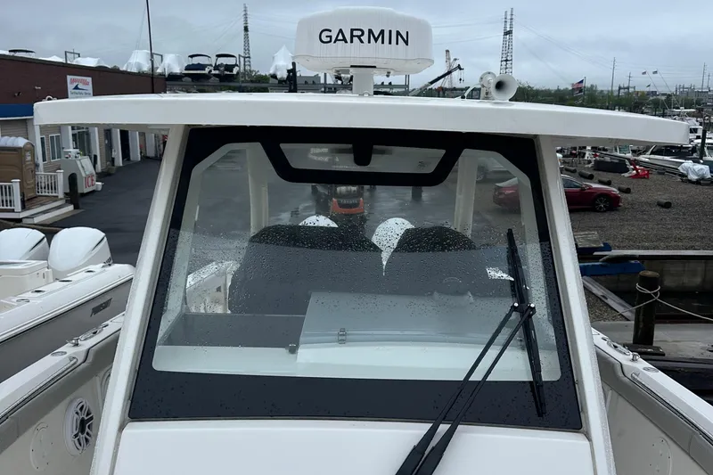 Slide: The Image of 2024 Pursuit S 328 Sport boat with Garmin equipment, docked on a rainy day. - 25