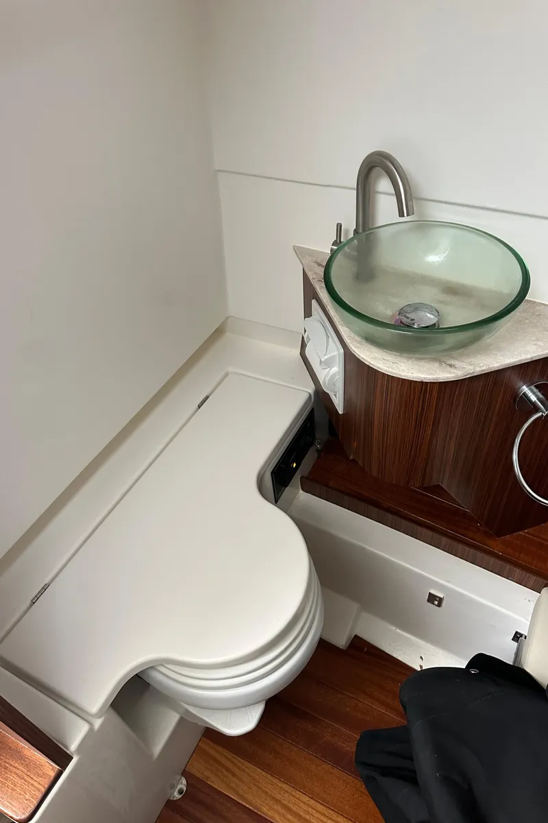 Slide: The Image of 2024 Pursuit S 328 Sport boat bathroom with modern sink and compact toilet design. - 26