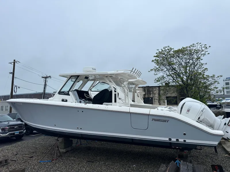 Slide: The Image of 2024 Pursuit S 328 Sport boat on display, featuring sleek design and dual engines. - 3