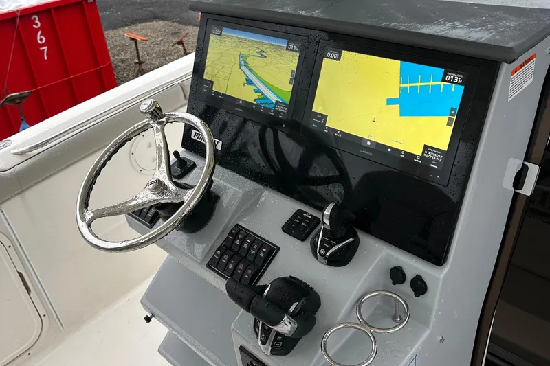 Slide: The Image of 2024 Pursuit S 328 Sport boat dashboard with dual navigation screens and steering wheel. - 8