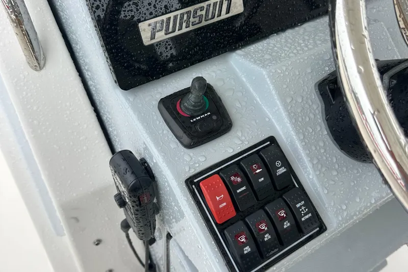 Slide: The Image of Control panel of 2024 Pursuit S 328 Sport boat with joystick and switches. - 9