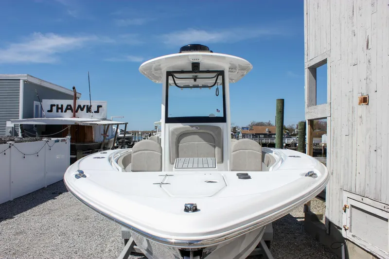Slide: The Image of 2025 Sea Hunt Ultra 275 SE boat docked, showcasing sleek design and spacious deck. - 11