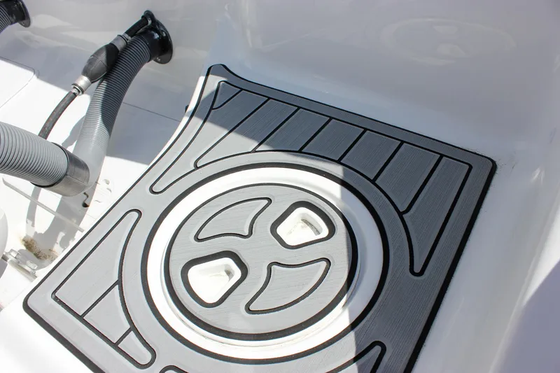 Slide: The Image of 2025 Sea Hunt Ultra 275 SE boat deck with non-slip mat and hose fittings. - 13