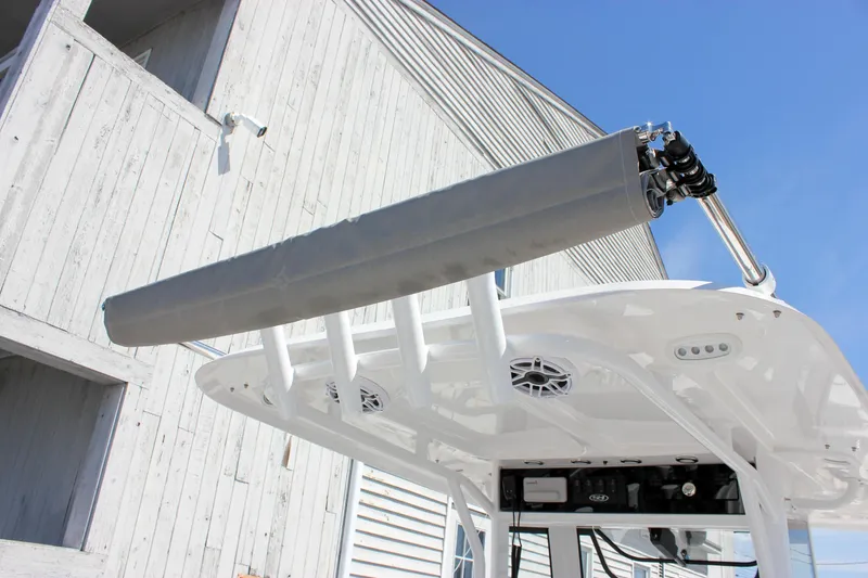 Slide: The Image of 2025 Sea Hunt Ultra 275 SE boat with T-top and rod holders against a clear sky. - 15