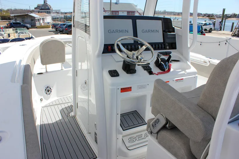Slide: The Image of 2025 Sea Hunt Ultra 275 SE boat cockpit with Garmin navigation system and comfortable seating. - 17
