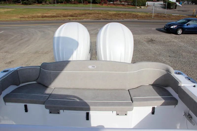 Slide: The Image of 2025 Sea Hunt Ultra 275 SE boat with dual engines and cushioned seating. - 18