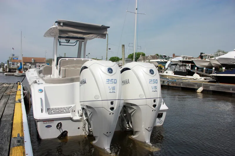 Slide: The Image of 2025 Sea Hunt Ultra 275 SE boat with twin Yamaha 250 V6 engines docked at marina. - 2