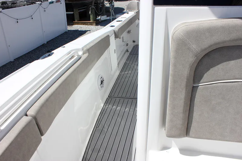 Slide: The Image of 2025 Sea Hunt Ultra 275 SE boat interior with cushioned seating and sleek flooring. - 21