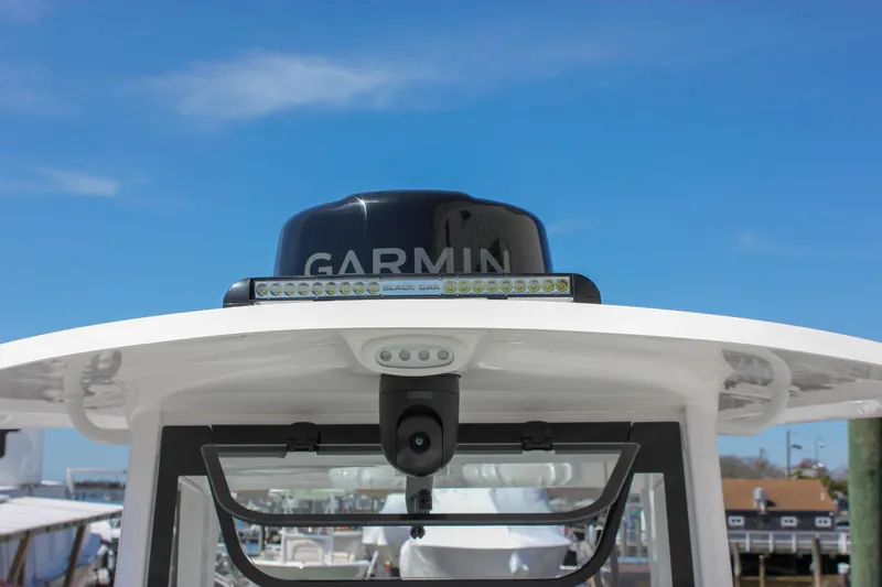 Slide: The Image of 2025 Sea Hunt Ultra 275 SE boat with Garmin radar and LED lights under clear sky. - 23