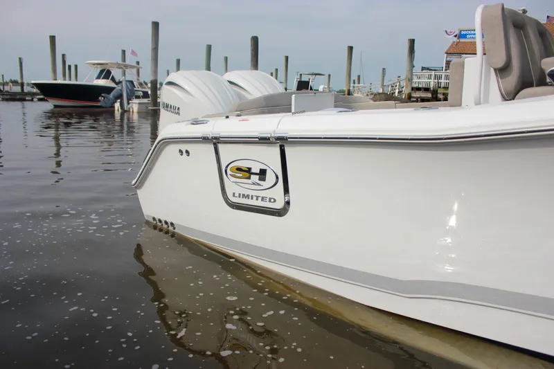 Slide: The Image of 2025 Sea Hunt Ultra 275 SE boat docked in marina, side view. - 3
