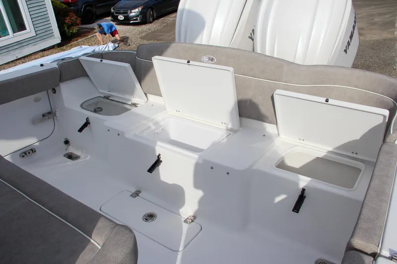 Slide: The Image of 2025 Sea Hunt Ultra 275 SE boat with open storage compartments and Yamaha engines. - 30