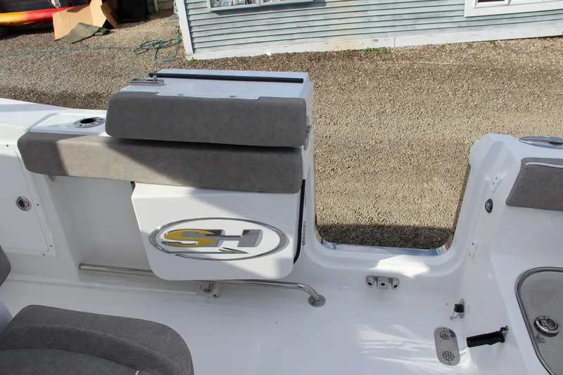 Slide: The Image of 2025 Sea Hunt Ultra 275 SE boat interior with gray seating and storage compartment. - 31