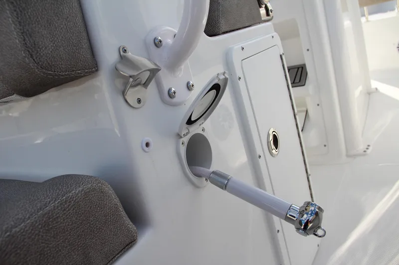 Slide: The Image of 2025 Sea Hunt Ultra 275 SE boat interior detail with rod holder and storage compartment. - 34