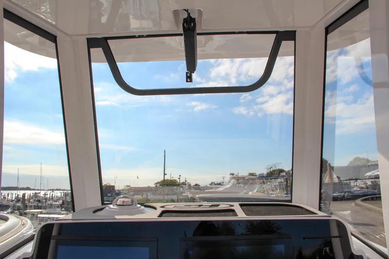 Slide: The Image of Interior view from Sea Hunt Ultra 275 SE boat, showcasing dashboard and clear sky, 2025 model. - 41