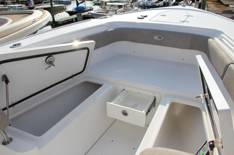 Slide: The Image of 2025 Sea Hunt Ultra 275 SE boat interior with open storage compartments. - 42