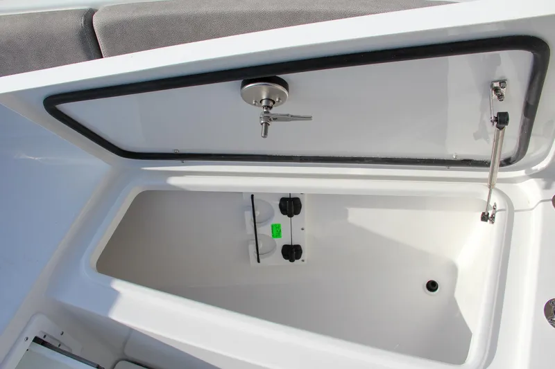 Slide: The Image of 2025 Sea Hunt Ultra 275 SE storage compartment with open lid and secure latch. - 44