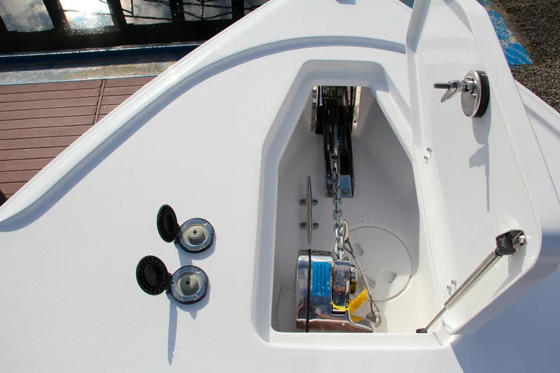 Slide: The Image of Anchor compartment of 2025 Sea Hunt Ultra 275 SE boat, featuring chain and winch system. - 45