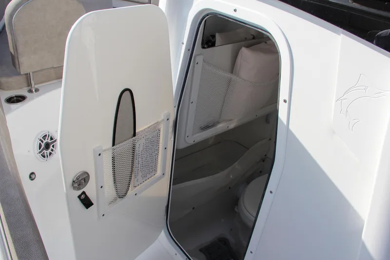 Slide: The Image of 2025 Sea Hunt Ultra 275 SE boat interior with open door revealing storage and seating. - 48