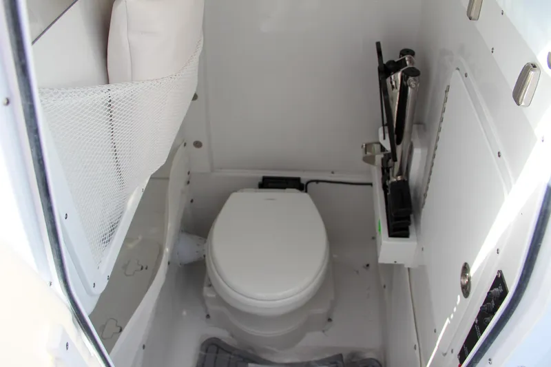 Slide: The Image of 2025 Sea Hunt Ultra 275 SE boat interior with compact marine toilet. - 49
