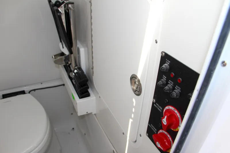 Slide: The Image of Interior of 2025 Sea Hunt Ultra 275 SE boat, featuring control panel and toilet. - 50