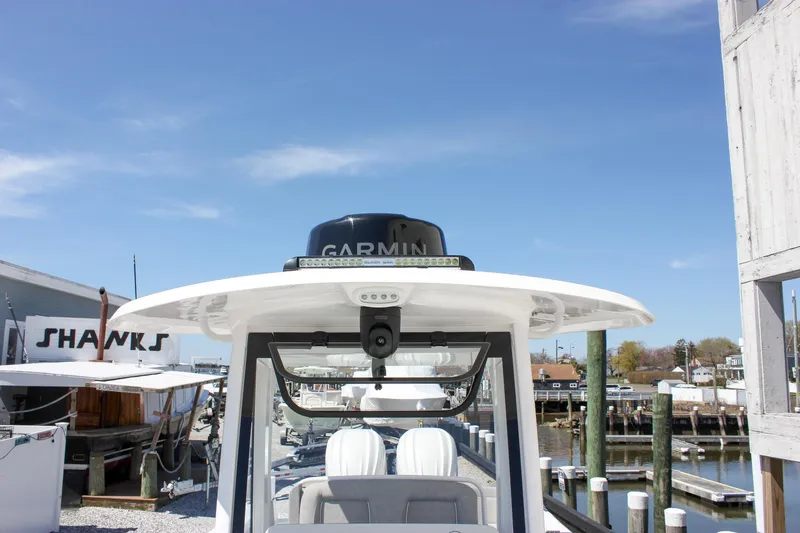 Slide: The Image of 2025 Sea Hunt Ultra 275 SE boat with Garmin equipment, docked under clear blue sky. - 52