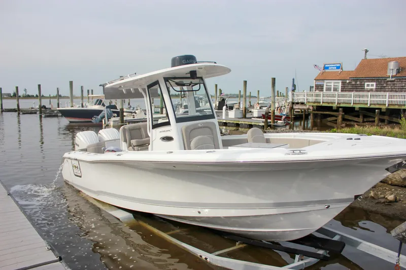 Slide: The Image of 2025 Sea Hunt Ultra 275 SE boat docked at marina, ready for launch. - 6