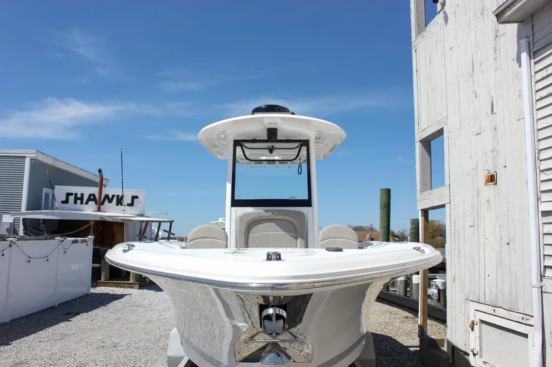 Slide: The Image of 2025 Sea Hunt Ultra 275 SE boat docked, front view, clear sky background. - 60