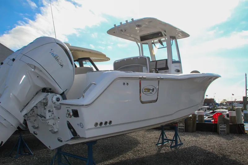 Slide: The Image of 2025 Sea Hunt Ultra 275 SE boat on display, featuring sleek design and powerful engine. - 61